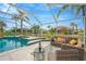 Covered patio area with seating overlooking the pool at 2357 Emerald Lake Dr, Sun City Center, FL 33573