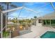 Lush patio area with seating and a screened pool at 2357 Emerald Lake Dr, Sun City Center, FL 33573