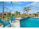 Inviting screened-in pool and spa with lounge chairs and lush surroundings at 2357 Emerald Lake Dr, Sun City Center, FL 33573