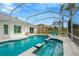 Relaxing screened pool and spa with patio furniture at 2357 Emerald Lake Dr, Sun City Center, FL 33573