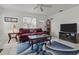 Living room with maroon couch, coffee table, and TV at 2401/2403 23Rd W Ave, Bradenton, FL 34205