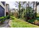 Landscaped backyard with lush greenery and a tranquil canal view at 3000 Red Oak Court # 103, Palm Harbor, FL 34684