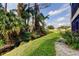 Landscaped backyard with lush greenery and a tranquil canal view at 3000 Red Oak Court # 103, Palm Harbor, FL 34684