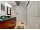 Bathroom with dark wood cabinets and granite countertops at 3000 Red Oak Court # 103, Palm Harbor, FL 34684