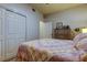 Well-lit bedroom with double bed and mirrored dresser at 3000 Red Oak Court # 103, Palm Harbor, FL 34684