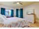 Bright bedroom featuring a floral comforter and white dresser at 3000 Red Oak Court # 103, Palm Harbor, FL 34684