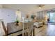 Light and airy dining area with a table for four at 3000 Red Oak Court # 103, Palm Harbor, FL 34684