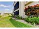 Building exterior showcasing a well-maintained garden at 3000 Red Oak Court # 103, Palm Harbor, FL 34684