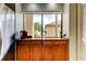 Kitchen features granite countertop, wooden cabinets, and a coffee maker at 3000 Red Oak Court # 103, Palm Harbor, FL 34684
