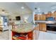 Open kitchen with breakfast bar and island at 3000 Red Oak Court # 103, Palm Harbor, FL 34684