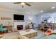 Bright living room with fireplace, hardwood floors, and open concept dining area at 3000 Red Oak Court # 103, Palm Harbor, FL 34684