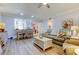 Open living area with comfortable seating and a view into the dining area at 3000 Red Oak Court # 103, Palm Harbor, FL 34684