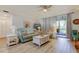 Relaxing living room with comfy seating and sliding doors to patio at 3000 Red Oak Court # 103, Palm Harbor, FL 34684