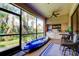Relaxing screened patio with seating area, kayak storage, and tranquil garden views at 3000 Red Oak Court # 103, Palm Harbor, FL 34684