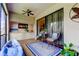 Bright screened patio features casual seating and a wet bar with storage at 3000 Red Oak Court # 103, Palm Harbor, FL 34684