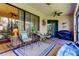 Spacious screened-in porch with seating area and grill at 3000 Red Oak Court # 103, Palm Harbor, FL 34684