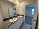 Bathroom with double sinks, granite countertop, and a separate shower at 32174 Turtle Grace Loop, Wesley Chapel, FL 33545