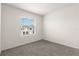 Well-lit bedroom featuring a large window and grey carpet at 32174 Turtle Grace Loop, Wesley Chapel, FL 33545