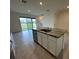 Open kitchen with island, stainless steel appliances, and granite countertops at 32174 Turtle Grace Loop, Wesley Chapel, FL 33545