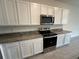 Kitchen with granite countertops and stainless steel appliances at 32174 Turtle Grace Loop, Wesley Chapel, FL 33545