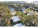Aerial view of a charming house nestled in a tree-lined neighborhood near the water at 3613 S Gardenia Ave, Tampa, FL 33629