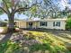Charming ranch home with blue shutters and a spacious yard at 3613 S Gardenia Ave, Tampa, FL 33629