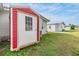 Red shed and grassy backyard with neighboring homes visible at 36901 Kimela Ave, Zephyrhills, FL 33542