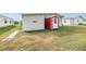 View of the backyard showing the red shed and home exterior at 36901 Kimela Ave, Zephyrhills, FL 33542