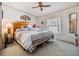 Bright bedroom with king-size bed and striped bedding at 36901 Kimela Ave, Zephyrhills, FL 33542