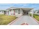 Single-wide manufactured home with carport and landscaped yard at 36901 Kimela Ave, Zephyrhills, FL 33542