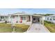 Single-wide manufactured home with carport and landscaped yard at 36901 Kimela Ave, Zephyrhills, FL 33542