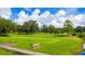Peaceful golf course scene with a bench overlooking a pond at 36901 Kimela Ave, Zephyrhills, FL 33542