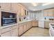 Kitchen with light wood cabinets, microwave, and dishwasher at 36901 Kimela Ave, Zephyrhills, FL 33542