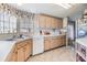 View of kitchen with light wood cabinets and corner sink at 36901 Kimela Ave, Zephyrhills, FL 33542