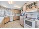 Bright kitchen featuring white appliances and wood cabinets at 36901 Kimela Ave, Zephyrhills, FL 33542