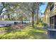 Landscaped backyard with a grassy area and trees at 37650 Aaralyn Rd, Zephyrhills, FL 33542