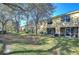 Townhouse backyards with screened patios and lawn at 37650 Aaralyn Rd, Zephyrhills, FL 33542
