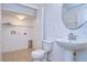 Small bathroom with pedestal sink, toilet, and linen closet at 37650 Aaralyn Rd, Zephyrhills, FL 33542