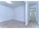 Empty bedroom with neutral carpeting and an adjacent room at 37650 Aaralyn Rd, Zephyrhills, FL 33542