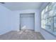 Bright bedroom featuring a window and closet at 37650 Aaralyn Rd, Zephyrhills, FL 33542