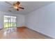 Spacious bedroom with wood flooring and sliding glass doors at 37650 Aaralyn Rd, Zephyrhills, FL 33542