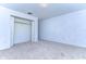 Empty bedroom with carpeted floor and a double-door closet at 37650 Aaralyn Rd, Zephyrhills, FL 33542