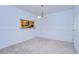 Bright dining room with kitchen view and neutral carpeting at 37650 Aaralyn Rd, Zephyrhills, FL 33542