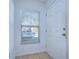 Bright entryway with tiled floor, window, and white door at 37650 Aaralyn Rd, Zephyrhills, FL 33542