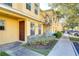 Yellow townhome with landscaping and sidewalk at 37650 Aaralyn Rd, Zephyrhills, FL 33542