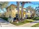 Tan two-story townhome with palm trees and manicured landscaping at 37650 Aaralyn Rd, Zephyrhills, FL 33542