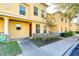 Yellow townhome with landscaping and sidewalk at 37650 Aaralyn Rd, Zephyrhills, FL 33542