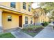 Yellow townhome with landscaping and sidewalk at 37650 Aaralyn Rd, Zephyrhills, FL 33542