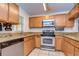 L-shaped kitchen with granite countertops and stainless steel appliances at 37650 Aaralyn Rd, Zephyrhills, FL 33542