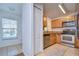 Kitchen features wood cabinets, granite counters, and stainless steel appliances at 37650 Aaralyn Rd, Zephyrhills, FL 33542